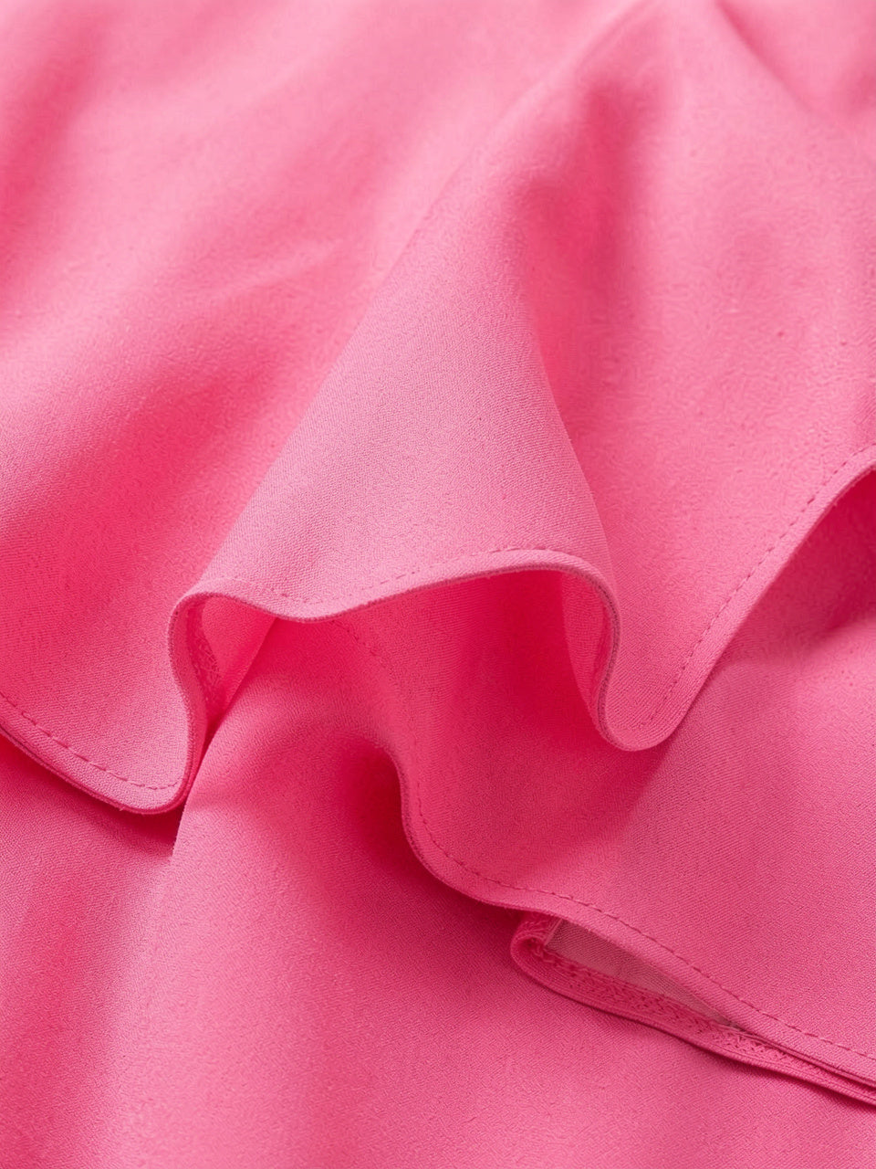 Close-up detail of pink ruffled flutter sleeve fabric