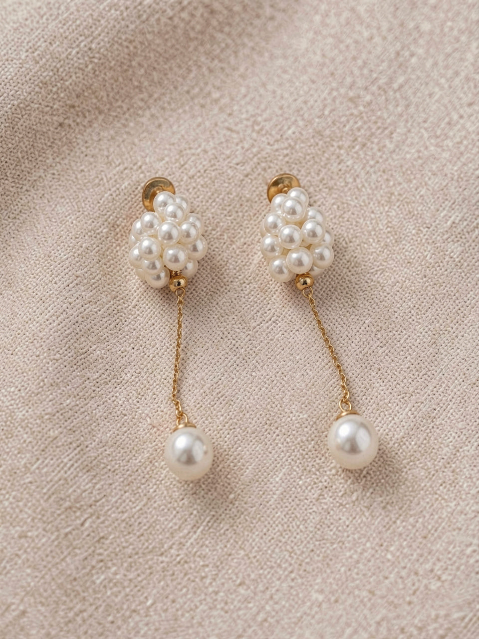 Close-up product detail of pearl cluster dangle earrings