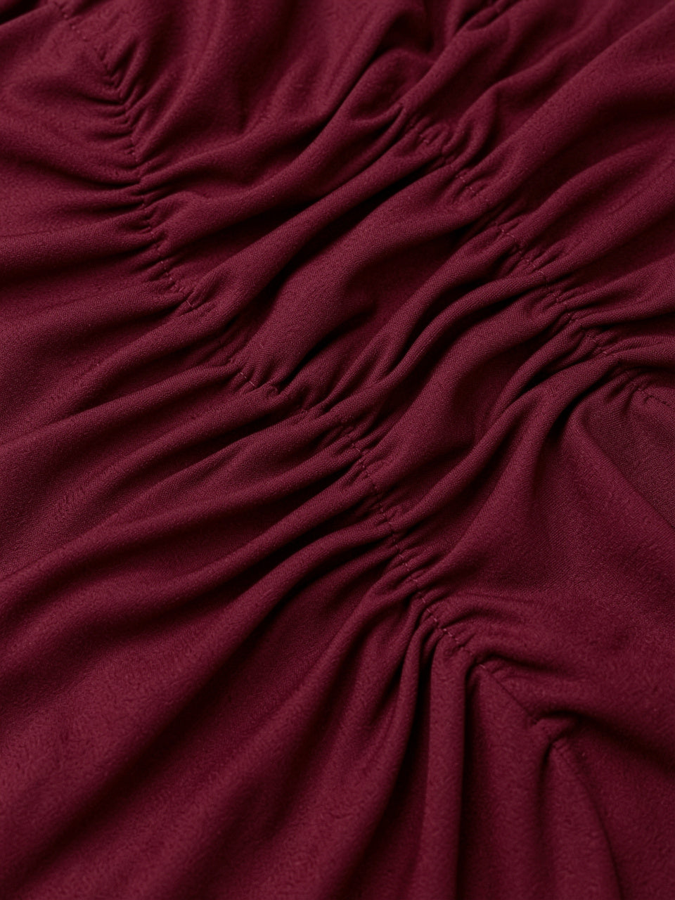 Close-up detail of ruched fabric texture on bodycon maxi dress