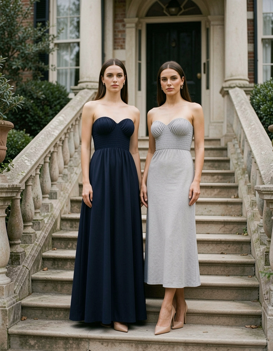 Two models wearing the Smocked Tube Maxi Dress, one in dark navy blue and one in light gray, both with strapless smocked bodice and A-line skirt