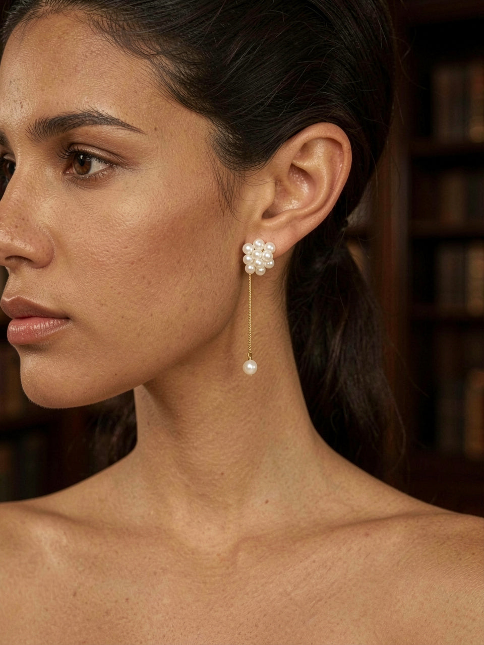 Pearl Cluster Dangle Earrings worn by model, close-up, library interior