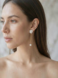 Pearl Cluster Dangle Earrings worn by model, close-up, marble interior