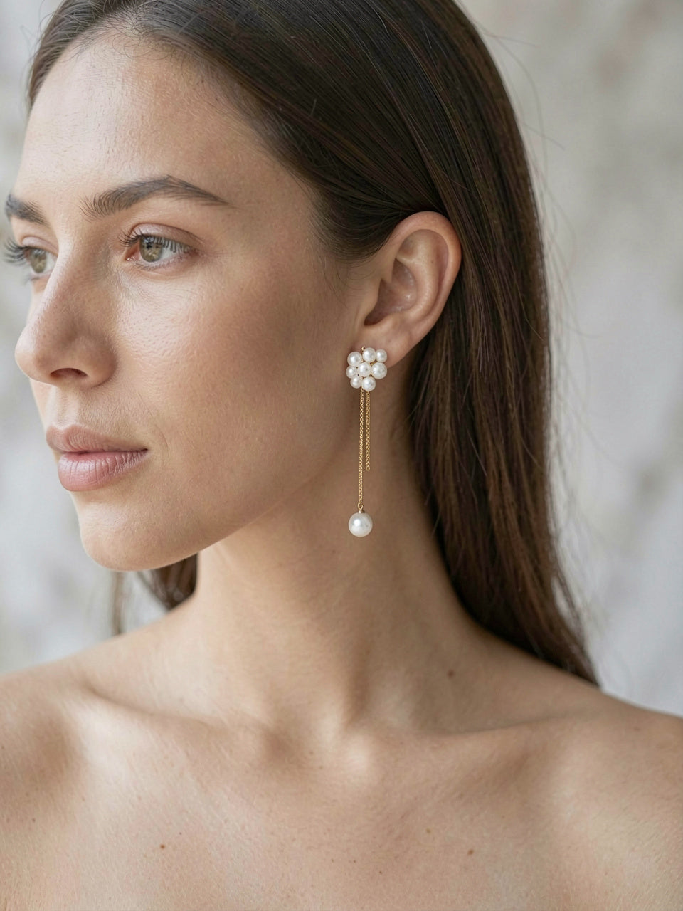 Pearl Cluster Dangle Earrings worn by model, close-up, marble interior